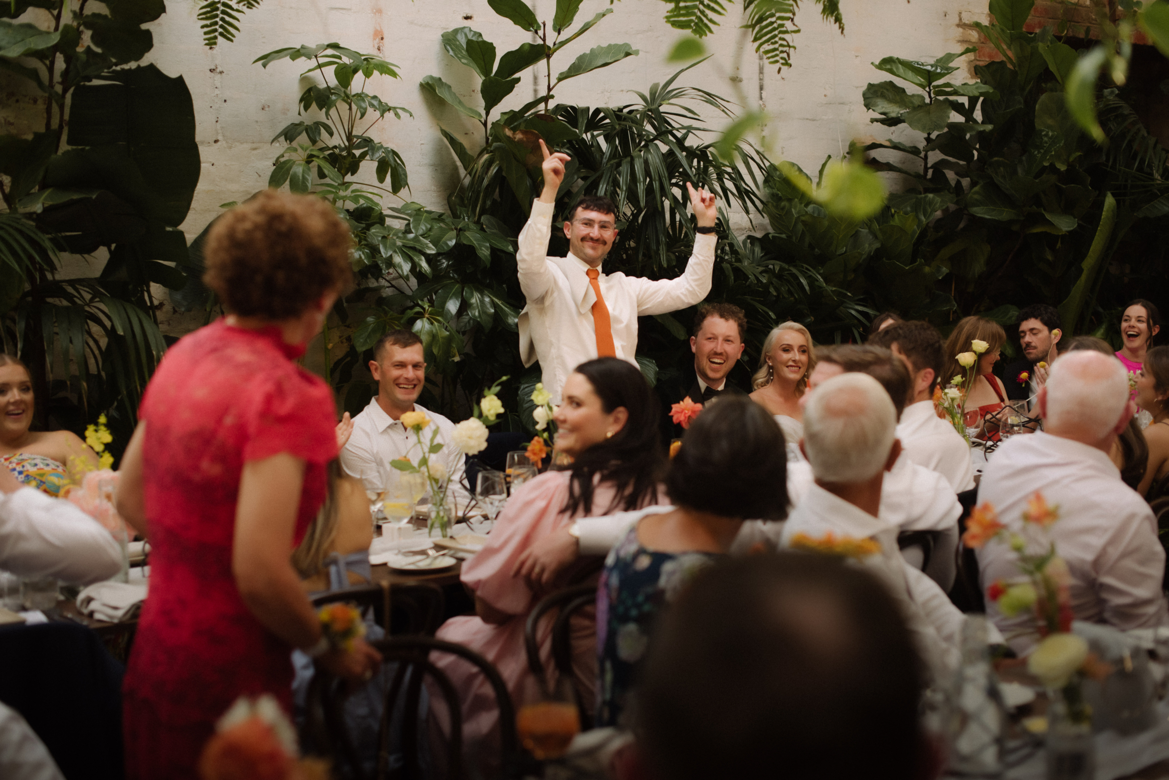 The best man at the wedding reception celebrating getting a correct answer in the couple quiz.