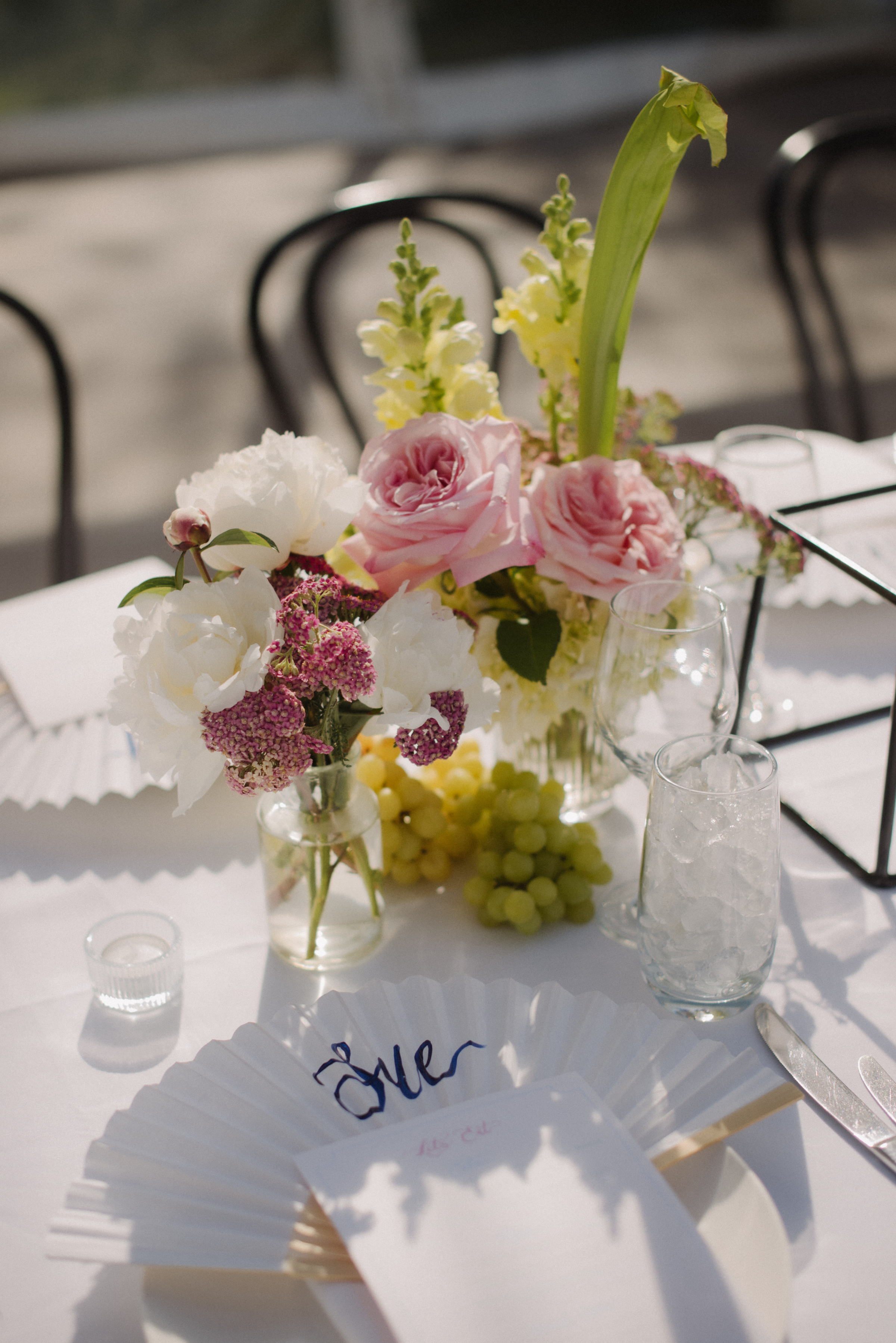 A floral display on a table setting for the wedding reception.